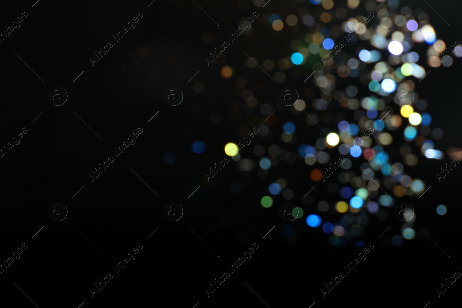 Photo of Blurred view of colorful festive lights on black background, space for text. Bokeh effect