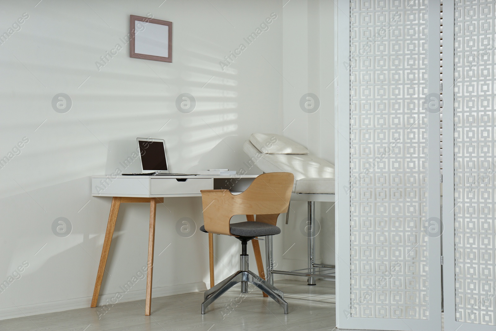 Photo of Doctor's workplace with laptop in modern clinic