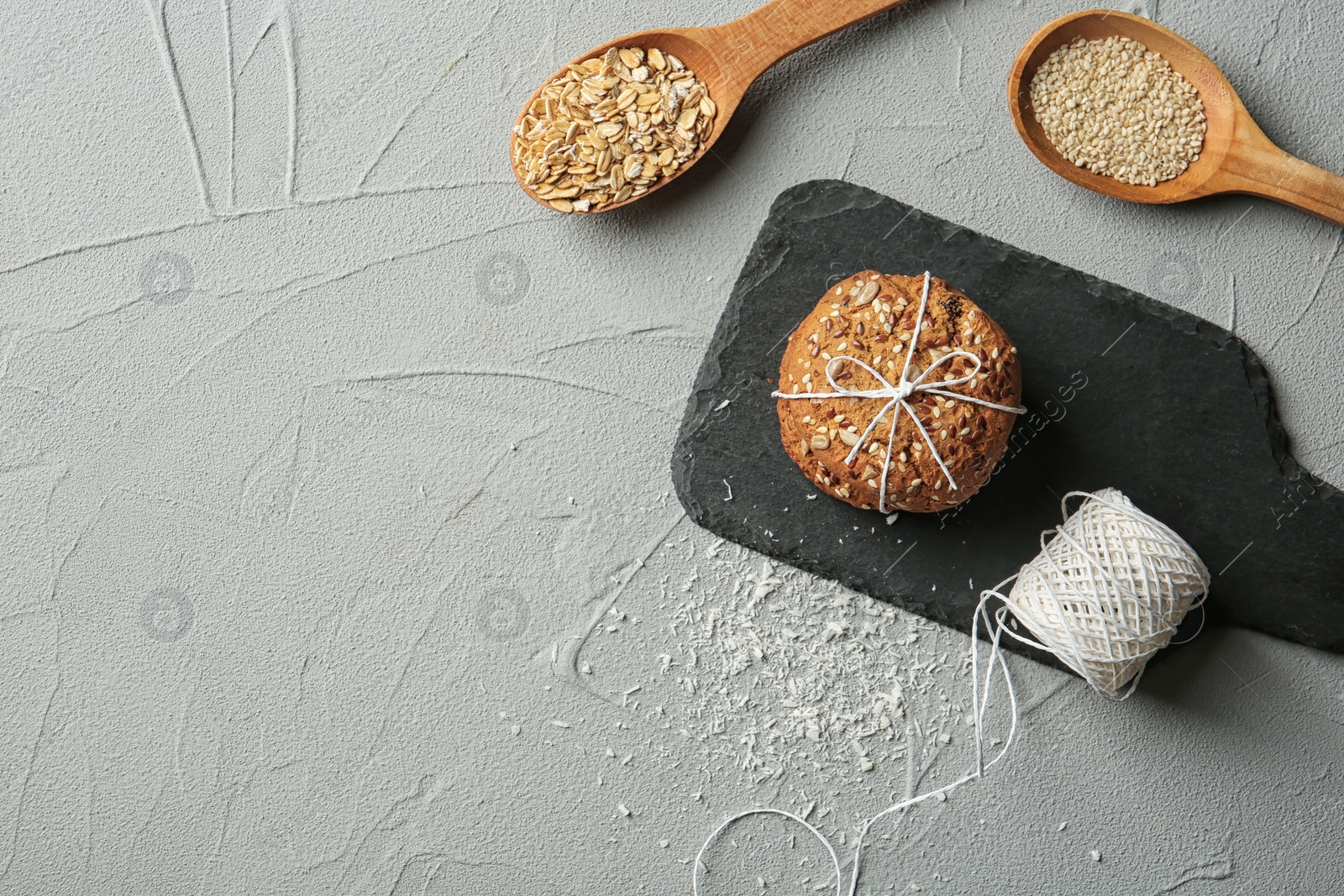 Photo of Slate plate with grain cereal cookies on table, top view. Healthy snack