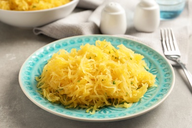 Photo of Plate with cooked spaghetti squash on table