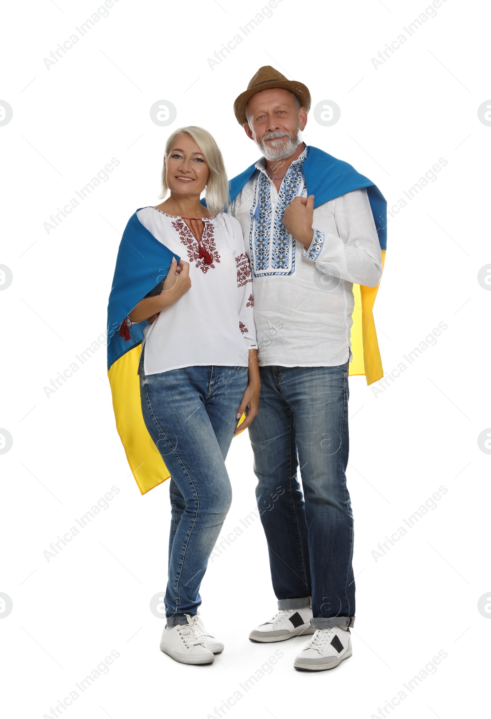 Photo of Happy mature couple with national flag of Ukraine on white background