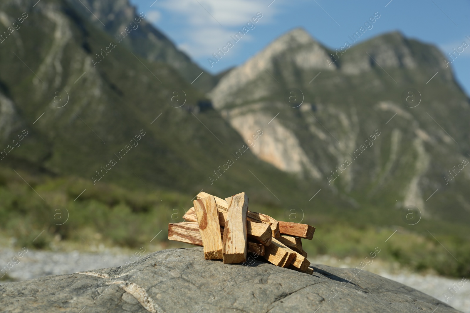 Photo of Many palo santo sticks on stone surface in high mountains