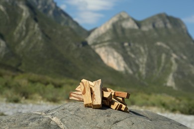 Many palo santo sticks on stone surface in high mountains