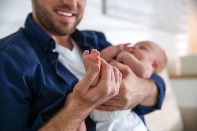 Photo of Father with his newborn son at home, closeup