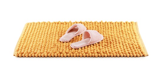 Photo of New yellow bath mat with soft slippers isolated on white