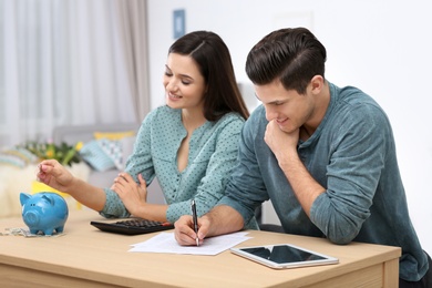 Photo of Young couple discussing pension plan at home