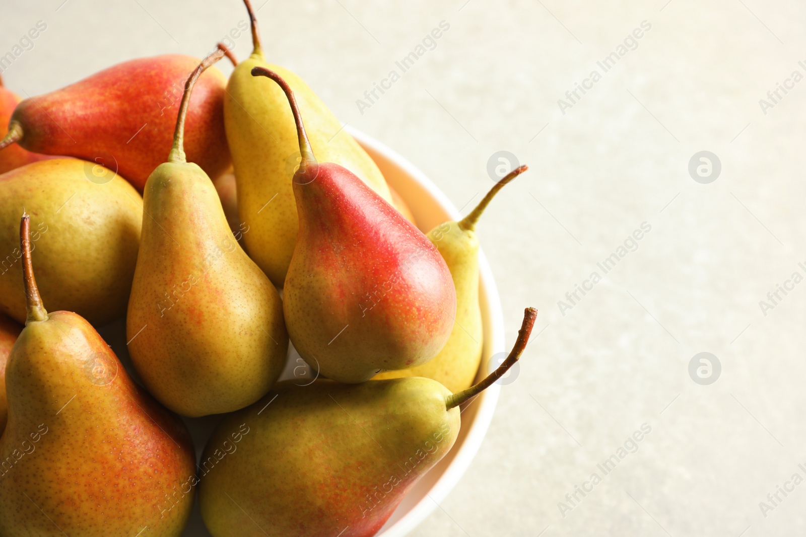 Photo of Plate with ripe pears on grey background. Space for text