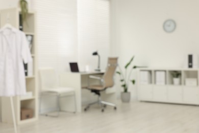 Photo of Blurred view of modern medical office with doctor's workplace in clinic