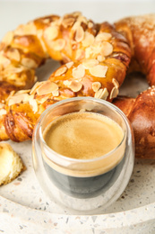 Fresh tasty pastries and coffee on tray, closeup