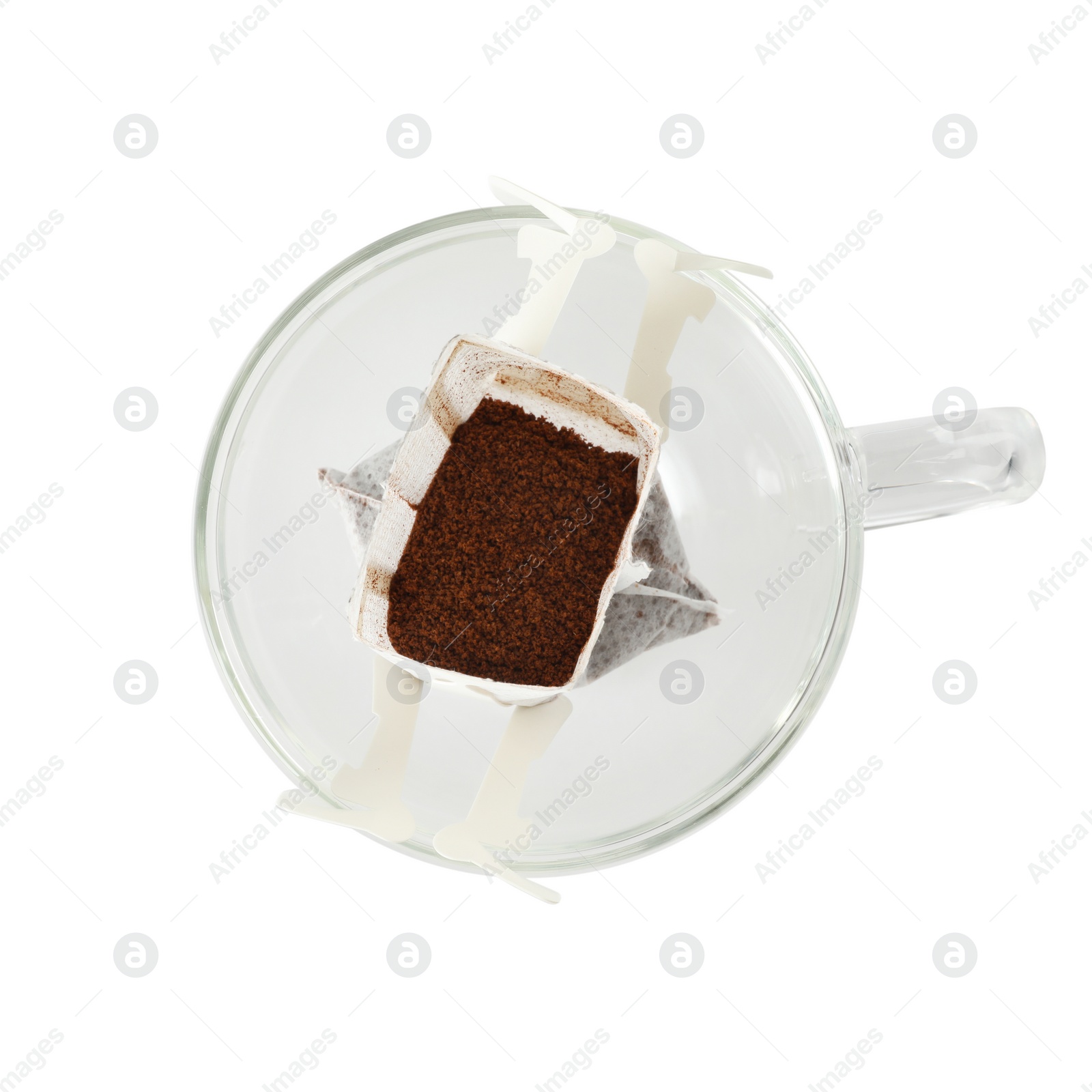 Photo of Glass cup with drip coffee bag isolated on white, top view