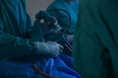 Photo of Professional doctors performing 
operation in surgery room, closeup