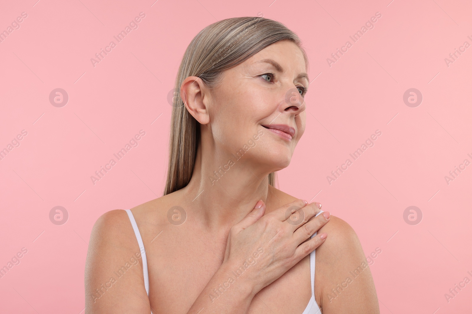 Photo of Beautiful woman with healthy skin on pink background