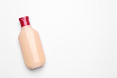 Photo of Bottle of shampoo on white background, top view. Space for text
