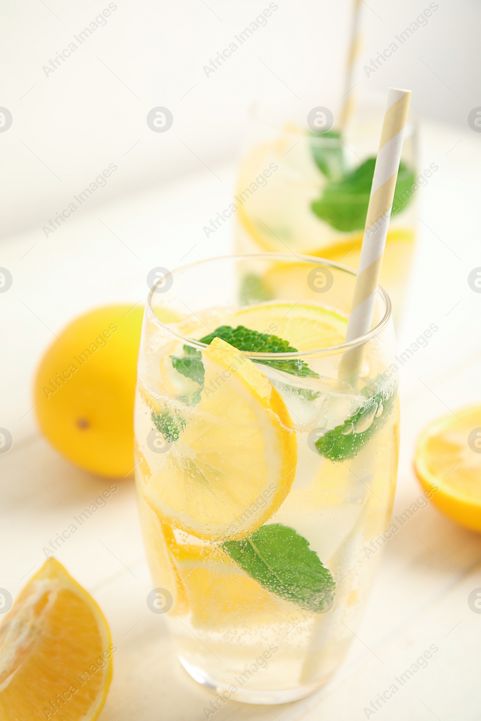 Photo of Cool freshly made lemonade and fruits on white wooden table