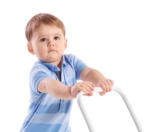 Cute baby playing with toy walker on white background