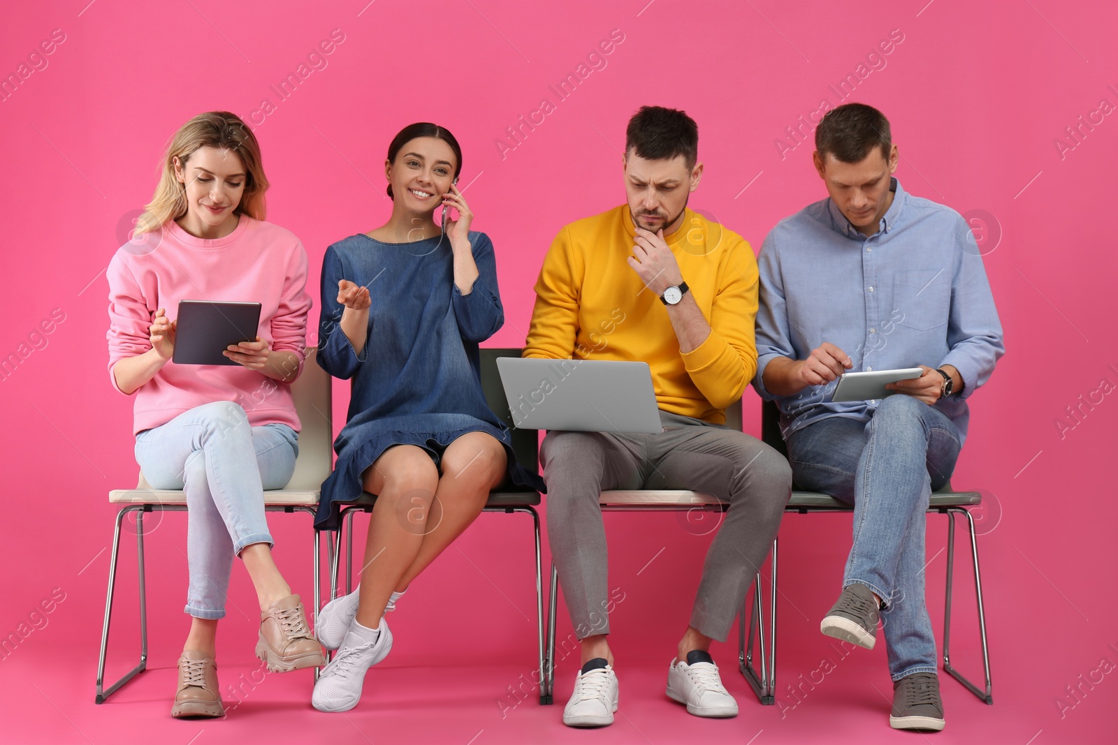 Photo of People waiting for job interview on pink background