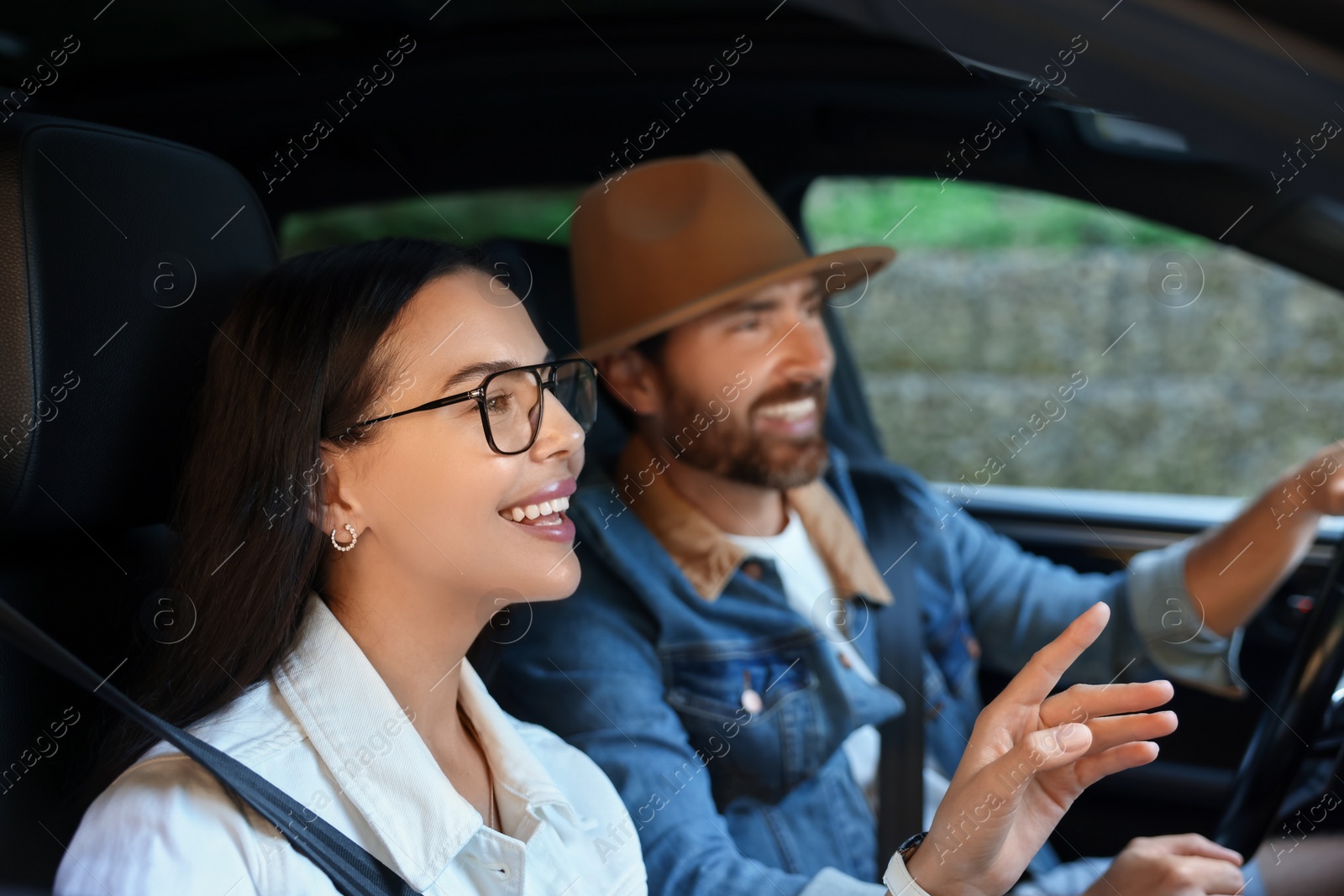 Photo of Happy couple enjoying trip together by car, selective focus