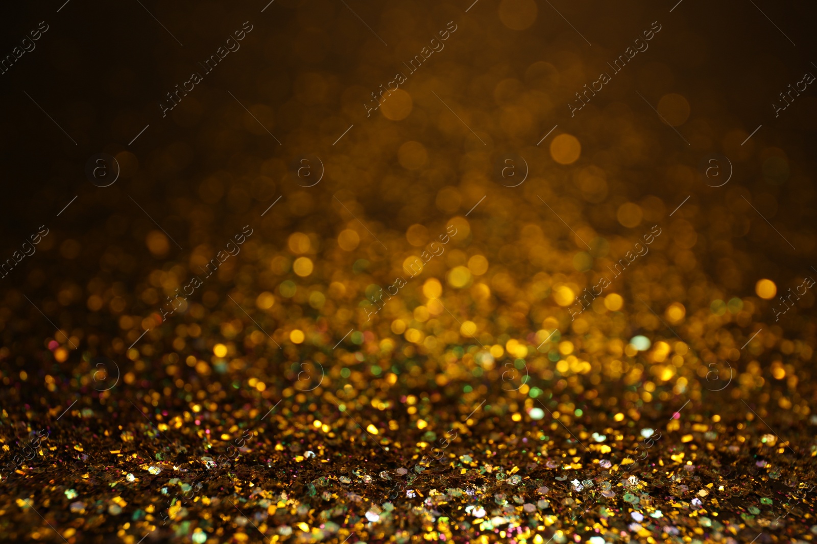 Photo of Shiny golden glitter as background. Bokeh effect