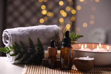 Photo of Beautiful composition with different spa products on table against blurred lights