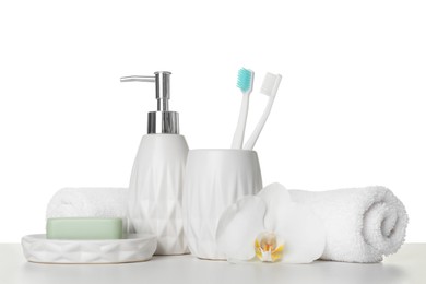 Photo of Bath accessories. Different personal care products and flower on table against white background