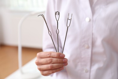 Photo of Speech therapist with logopedic probes in clinic, closeup