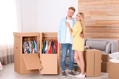 Young couple near wardrobe boxes at home