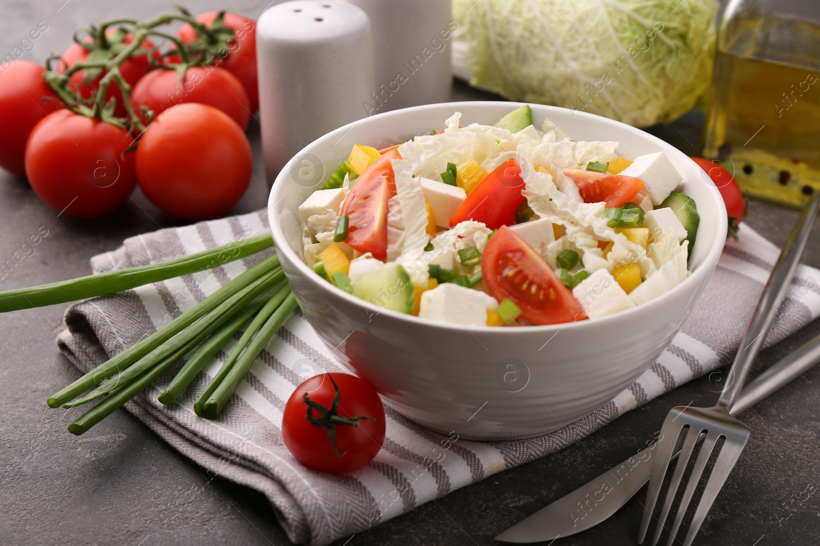 Photo of Tasty salad with Chinese cabbage served on grey table