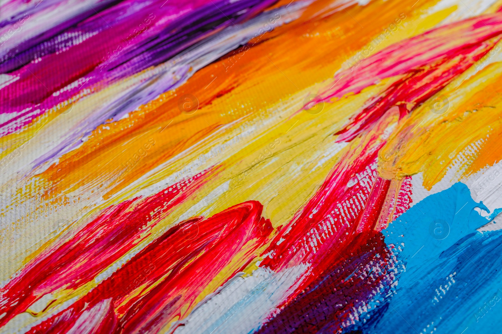 Photo of Beautiful strokes of colorful oil paints on white canvas as background, closeup