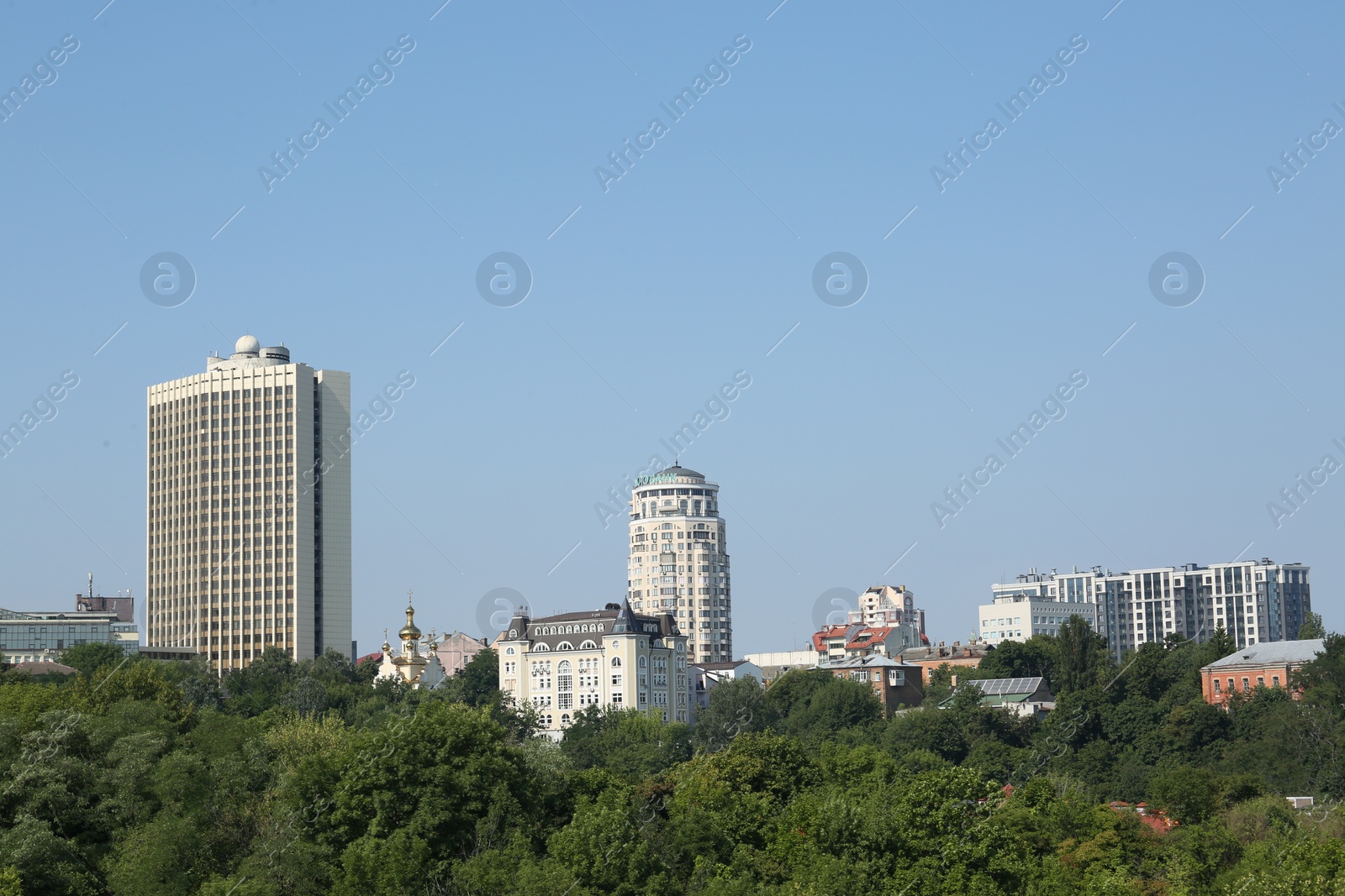 Photo of View of beautiful city with buildings and trees on sunny day