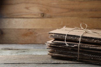 Stack of waste paper on wooden table, closeup. Space for text