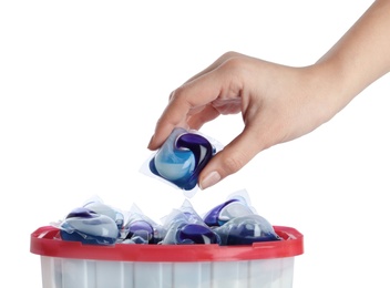 Photo of Woman taking laundry capsule out of box against white background, closeup