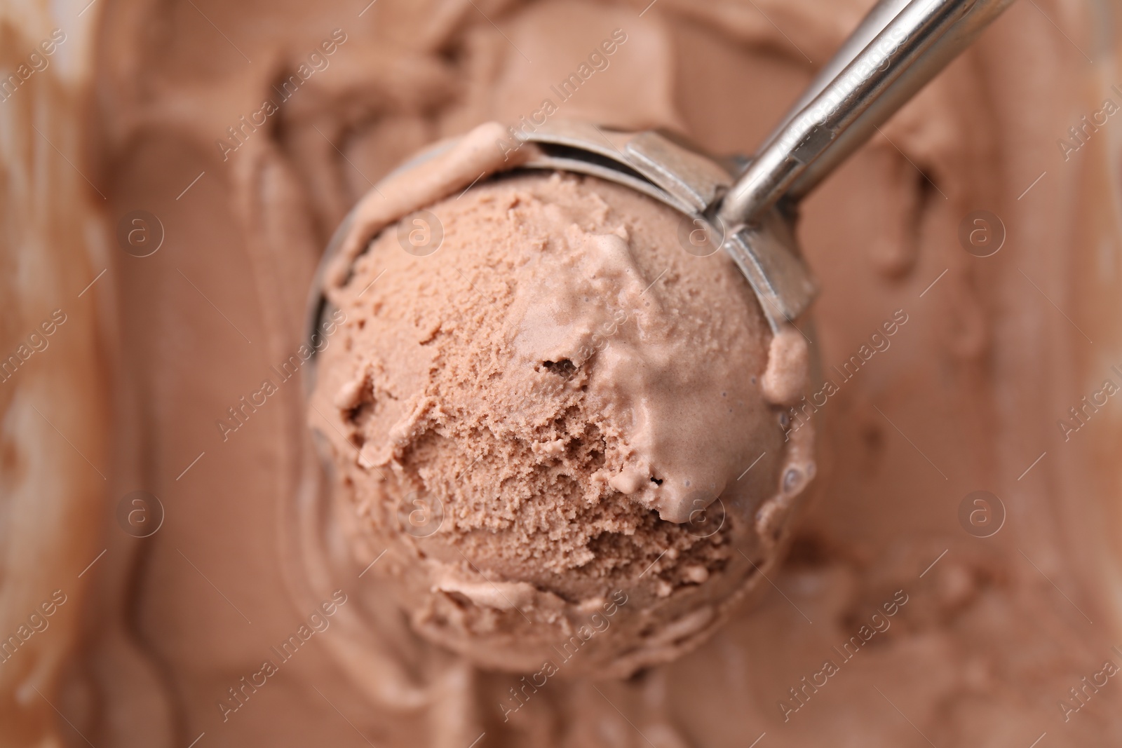 Photo of Taking tasty chocolate ice cream with scoop as background, closeup