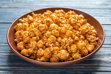 Photo of Delicious popcorn with caramel on plate