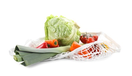 Photo of String bag with different vegetables isolated on white