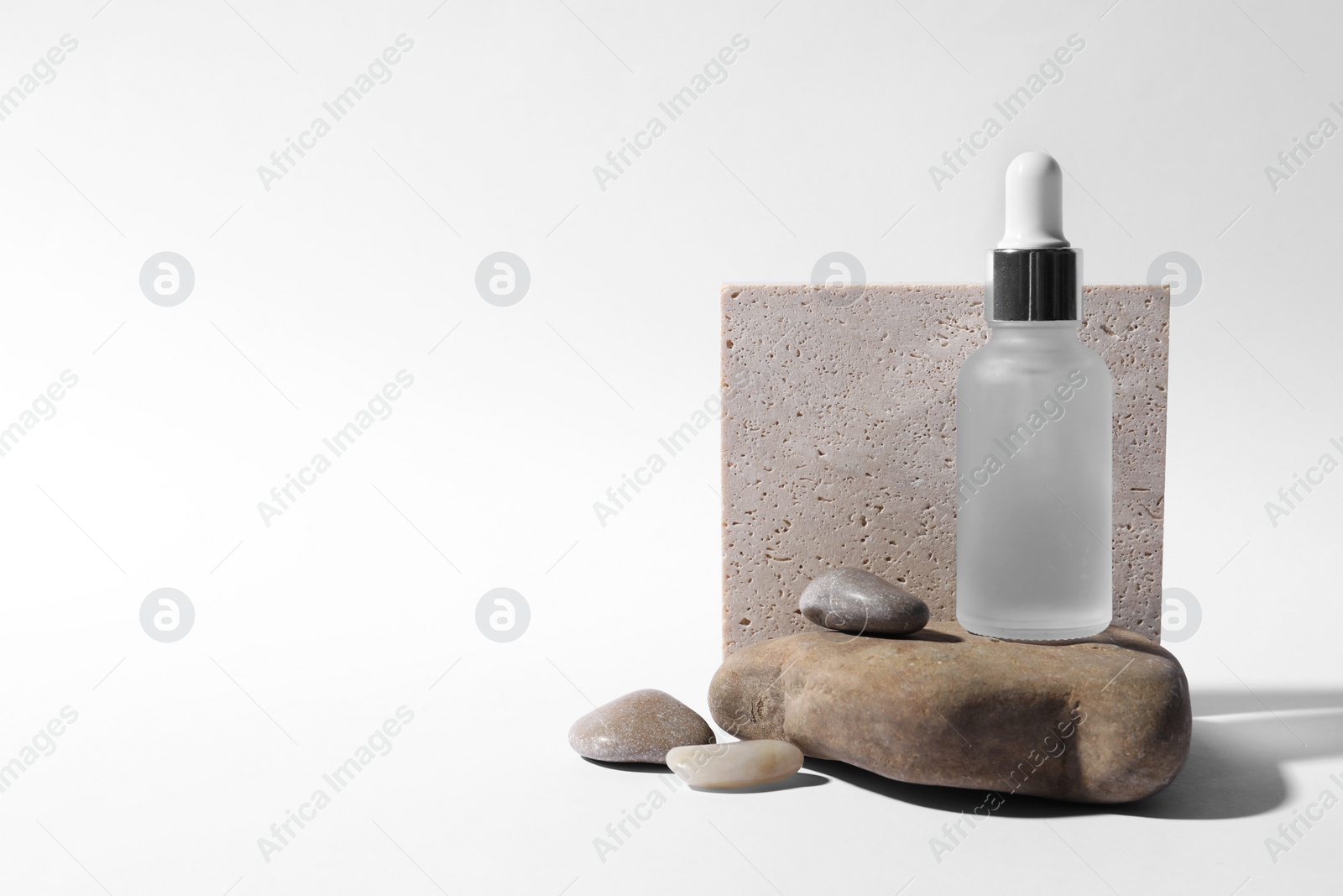 Photo of Composition with bottle of cosmetic serum on white background. Space for text