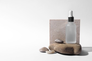 Photo of Composition with bottle of cosmetic serum on white background. Space for text