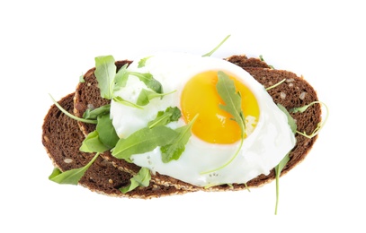 Photo of Delicious sandwich with arugula and fried egg isolated on white, top view
