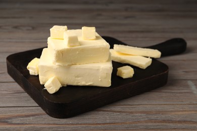 Pieces of tasty butter on wooden table