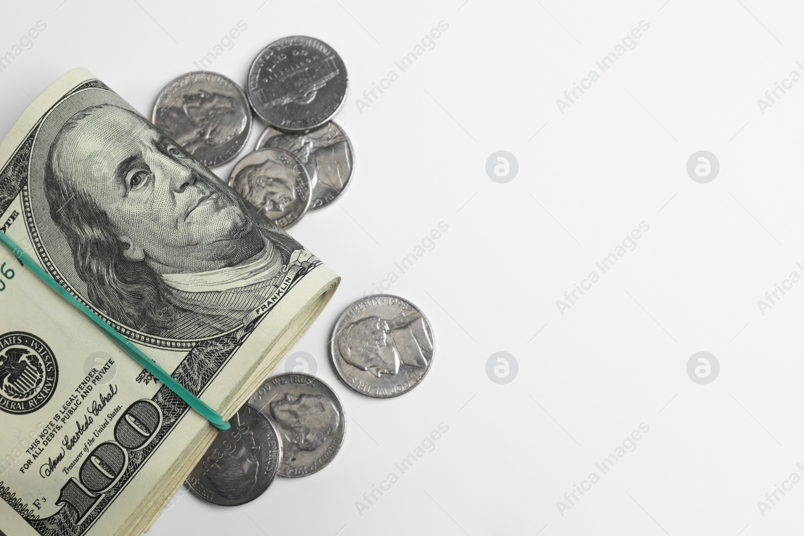 Photo of Money exchange. Dollar banknotes and coins on white background, flat lay. Space for text