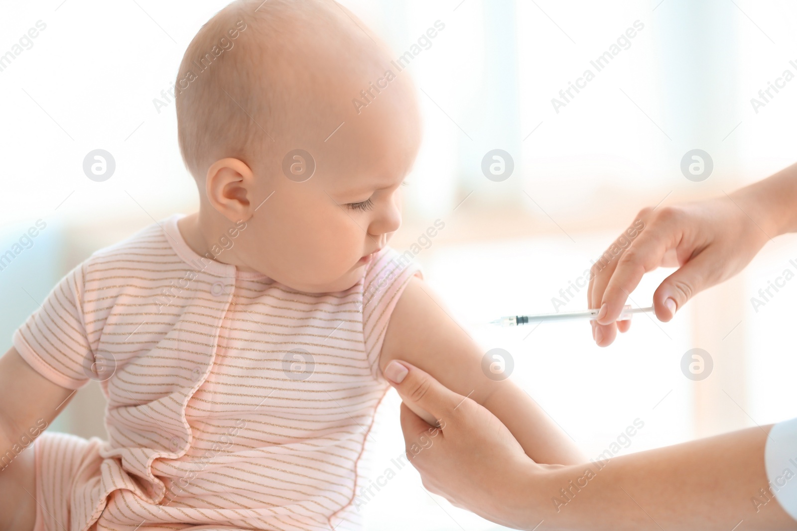 Photo of Doctor vaccinating baby in clinic