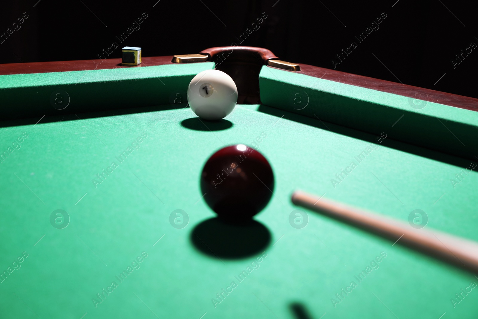 Photo of Striking red ball into billiard table pocket