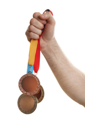 Man holding medals on white background, closeup. Space for design