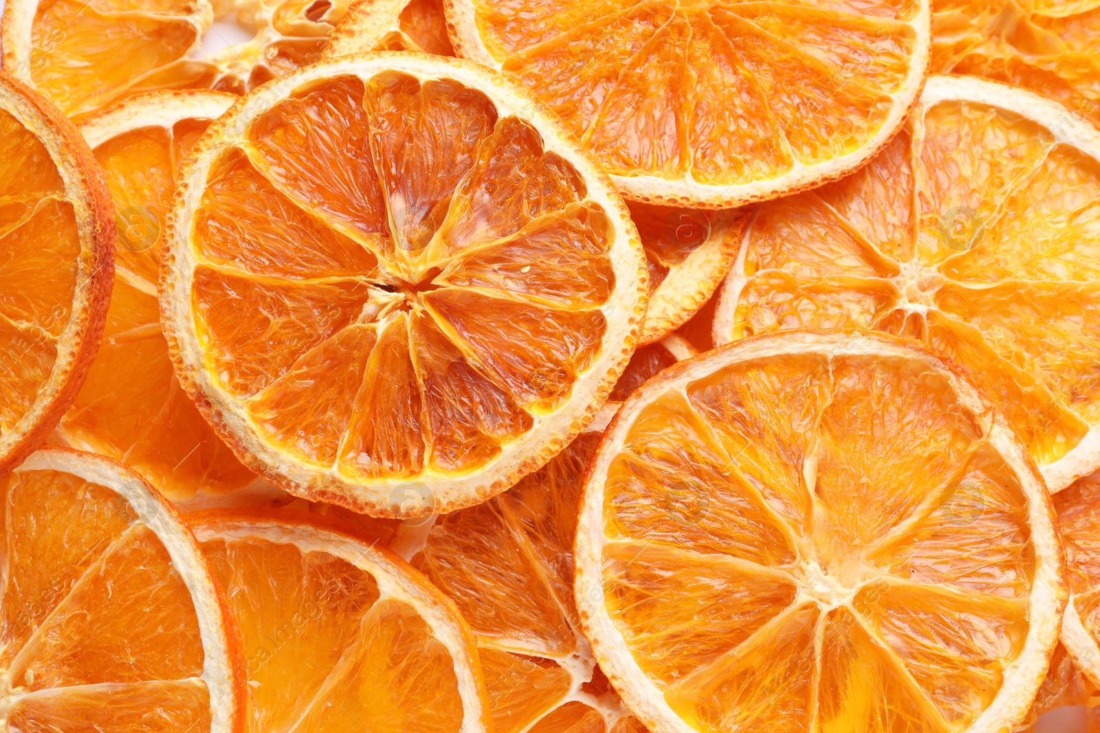 Delicious dry orange slices as background, top view Photo of Delicious dry orange slices as background, top view