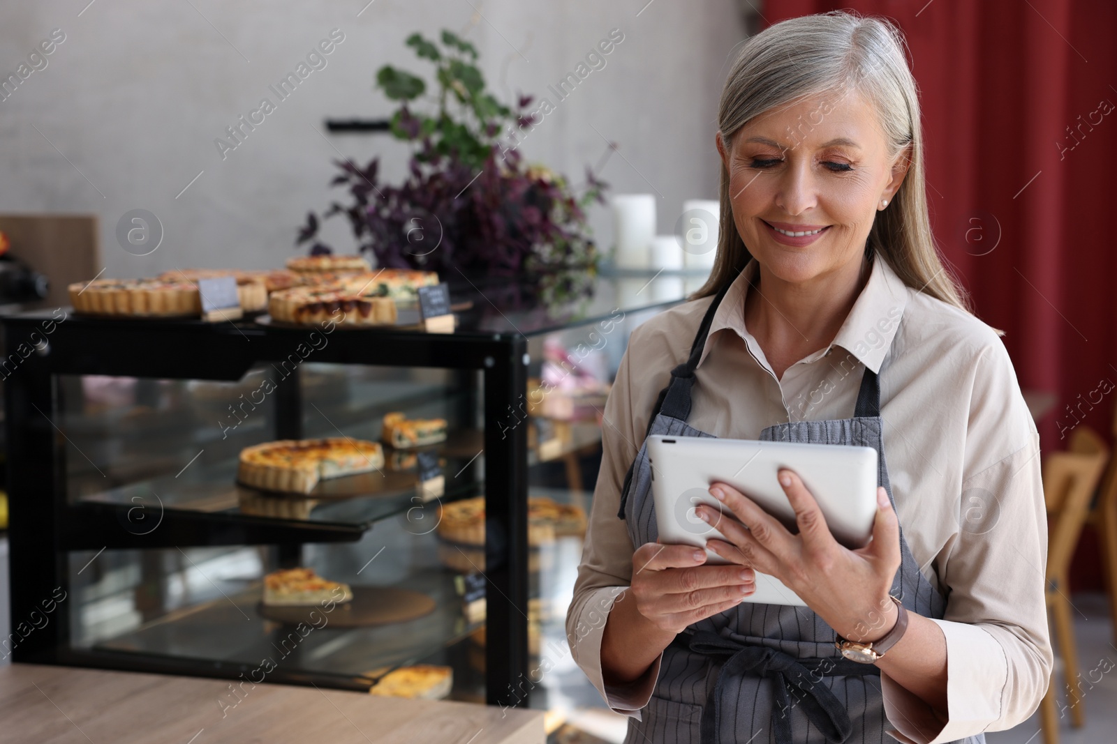 Photo of Happy business owner with tablet in her cafe, space for text