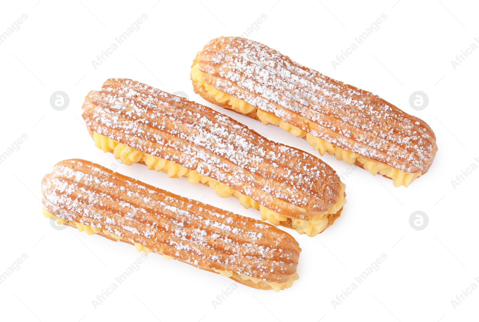 Photo of Delicious eclairs filled with cream isolated on white, top view