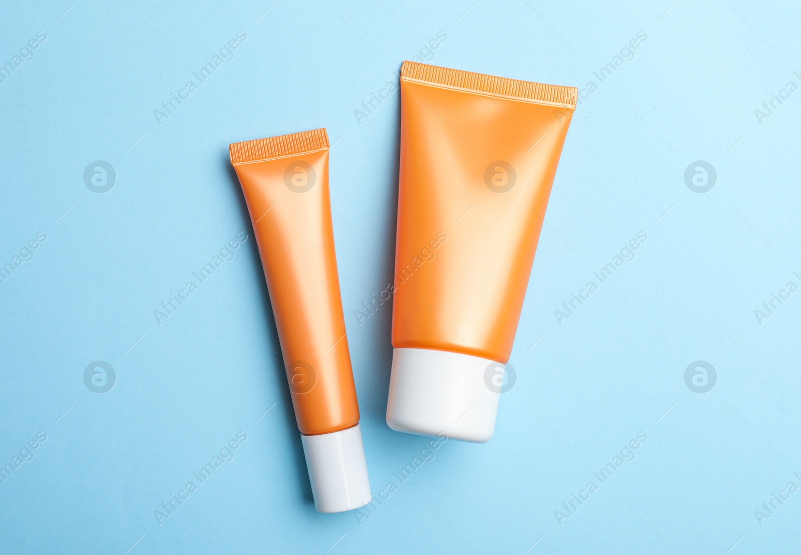 Photo of Set of luxury cosmetic products on light blue background, flat lay