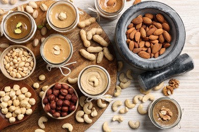 Making nut butters from different nuts. Flat lay composition on wooden table