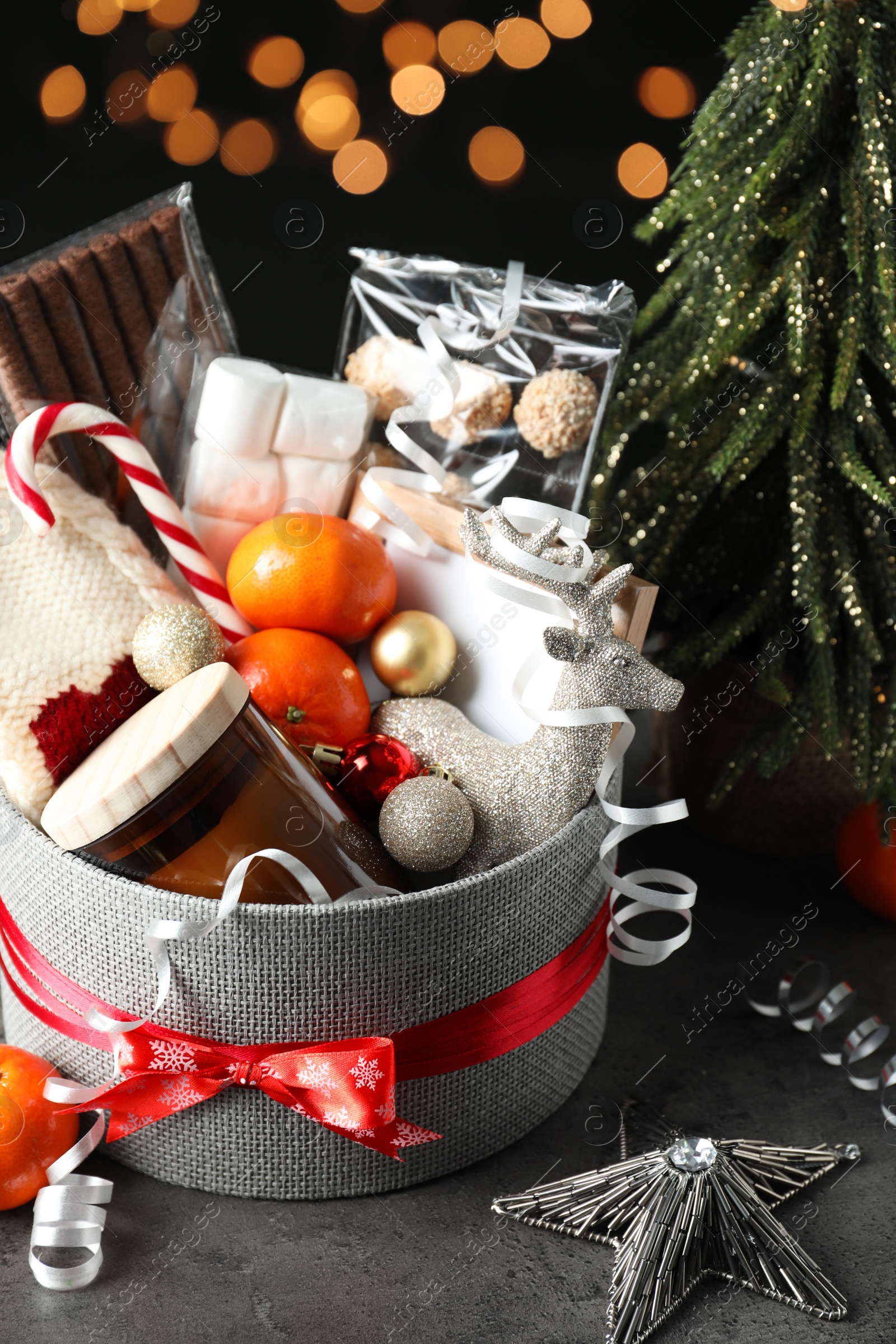 Photo of Basket with Christmas gift set on grey table