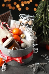 Basket with Christmas gift set on grey table