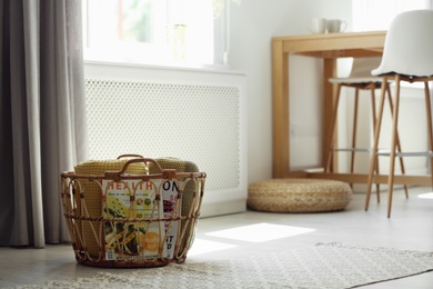 Basket with soft plaids in modern room interior